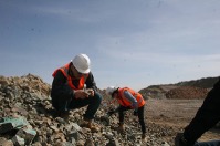 Workers examining rocks
